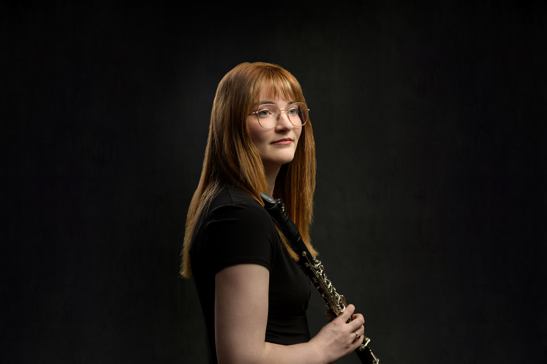 studio portrait of young woman with clarinet