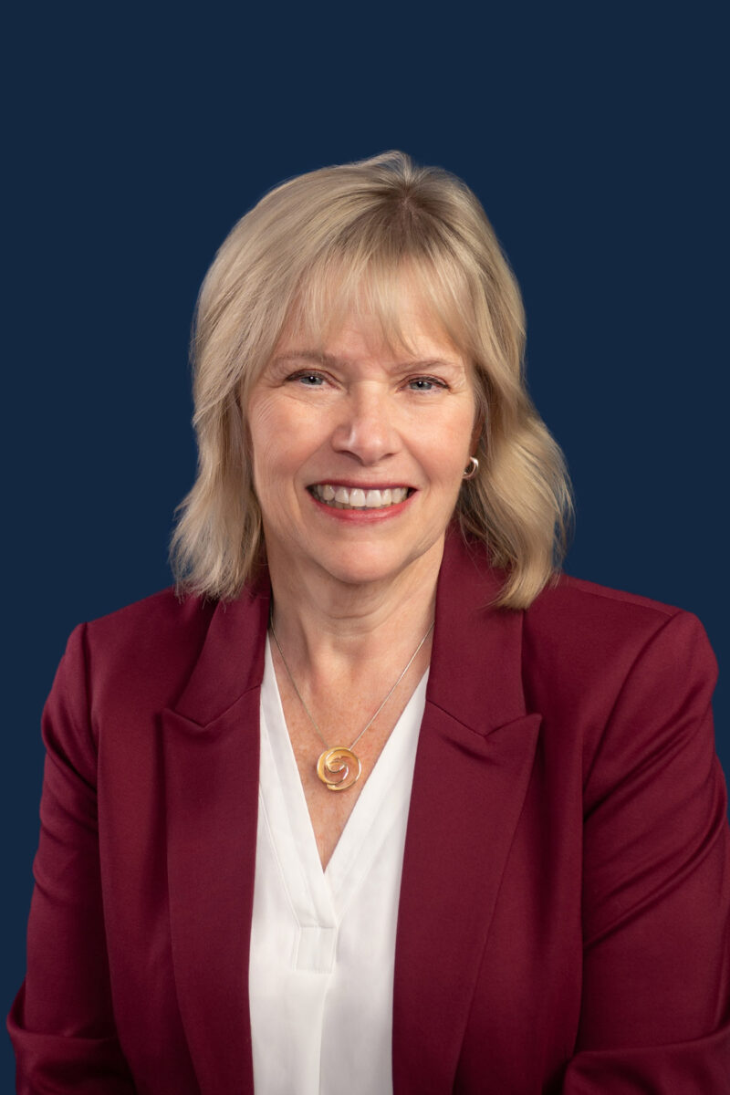 Halifax headshot photography woman on blue background with red blazer