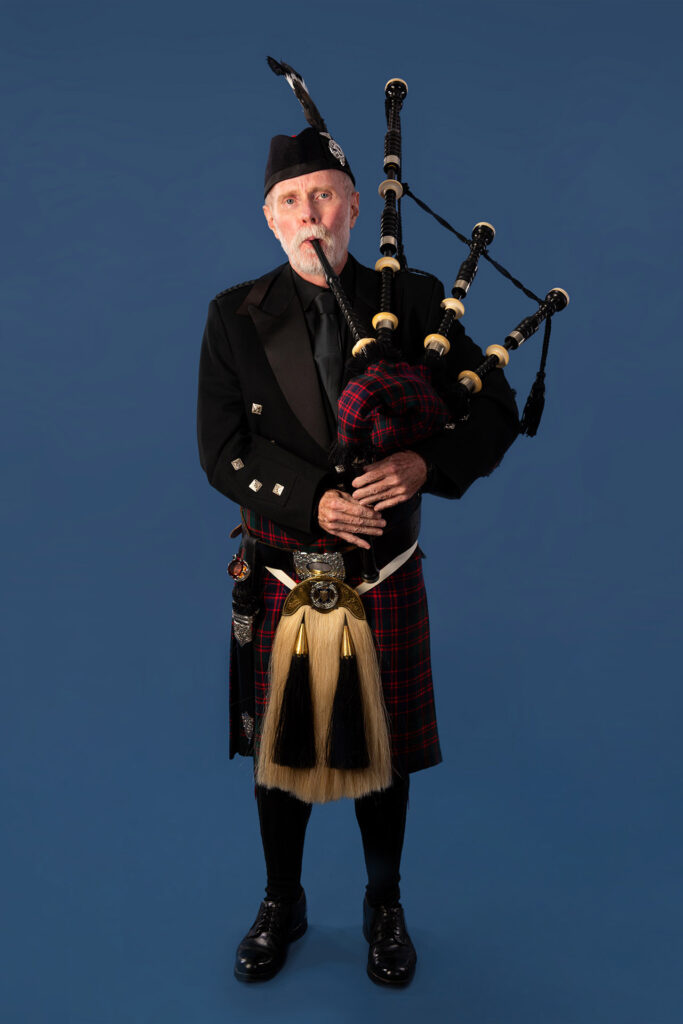 studio portrait of a bagpiper