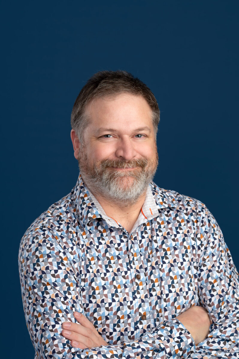 Man photographed on dark blue studio background headshot photography Halifax, NS