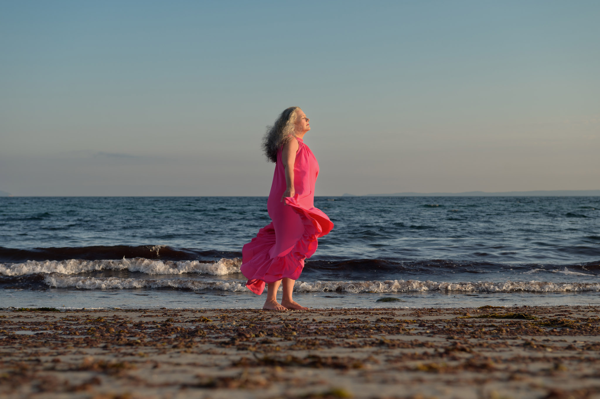 business headshots on the beach. woman in long flowy dress