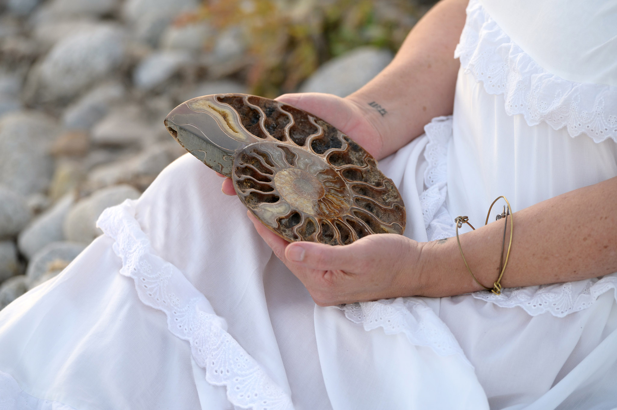 personal brand photoshoot. Woman holding fossil shell