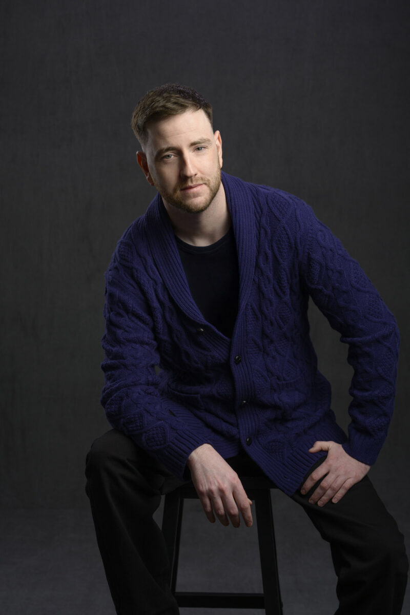 Man sitting on a stool in the Halifax headshot studio by Rebecca Clarke