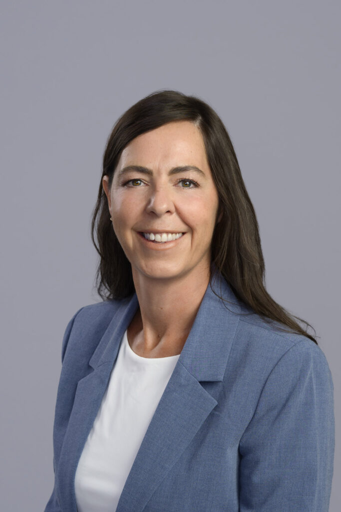 headshot of a woman on a light gray background