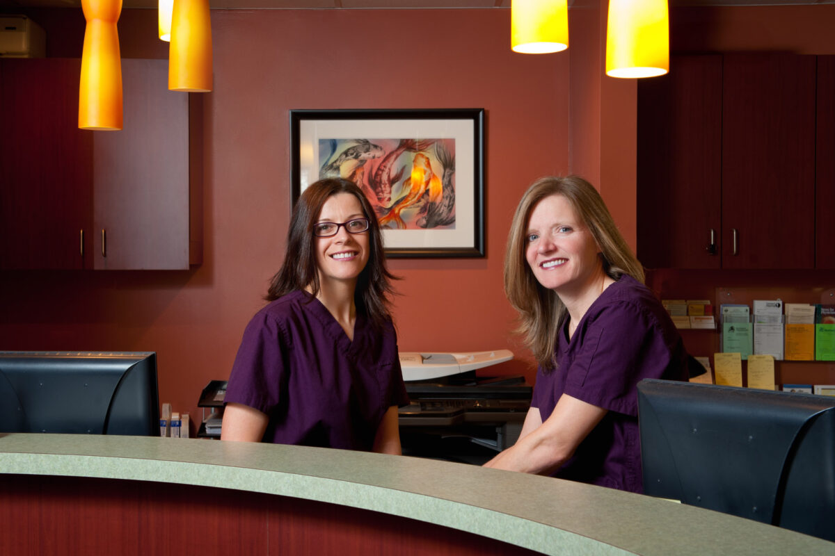In office portrait of two staff members at desk